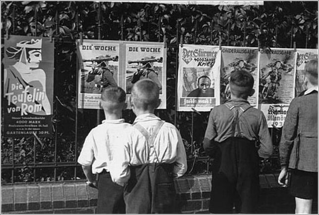 Berliin youth read posters from Der Stuermer